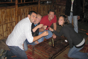 cheers Long before arriving in Vietnam our group of now 4 (me and Eric and two friends from Atlanta) had vowed to try the shot of the still beating snake hearts that we had heard so much about. Over the river in Hanoi, which is like the other side of the railroad tracks, there is a small village that the people here refer to as snake village. Our group prepared ourselves for this journey with a few cold beers and then hopped in a taxi with a guide from our hotel.